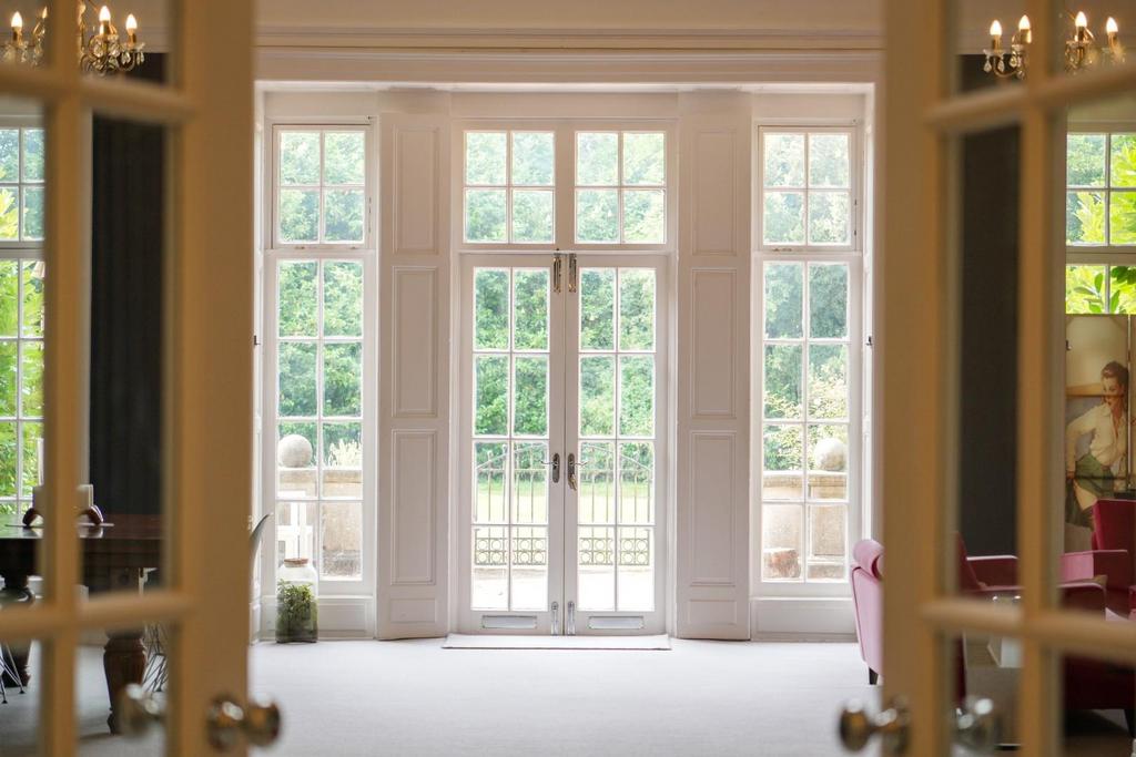 Conservatory interior, french doors leading to garden