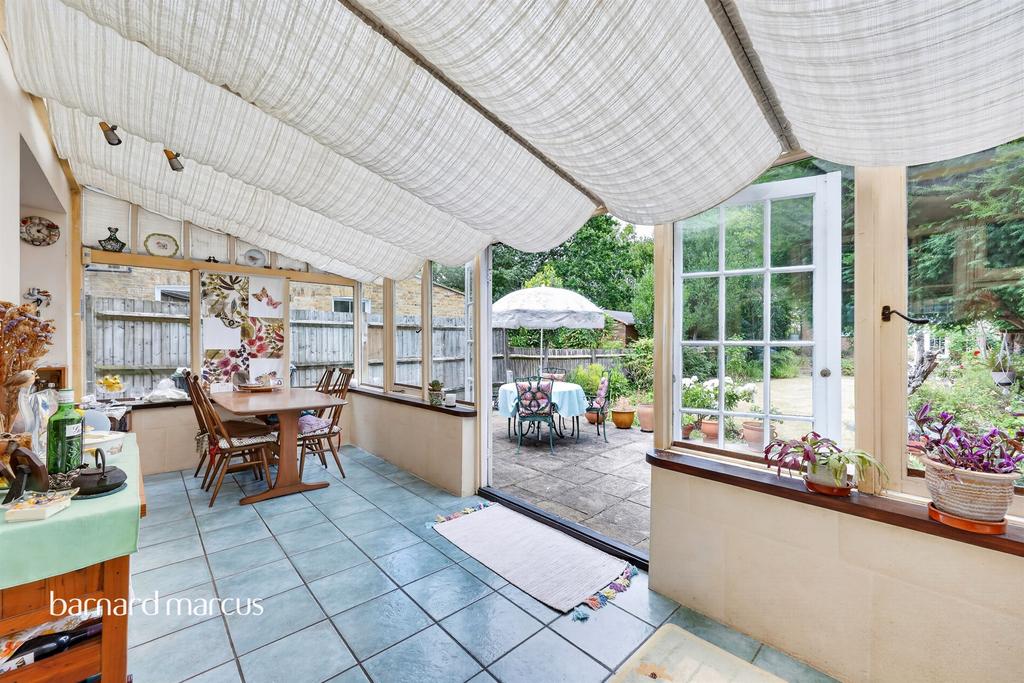 Conservatory interior, french doors leading to garden