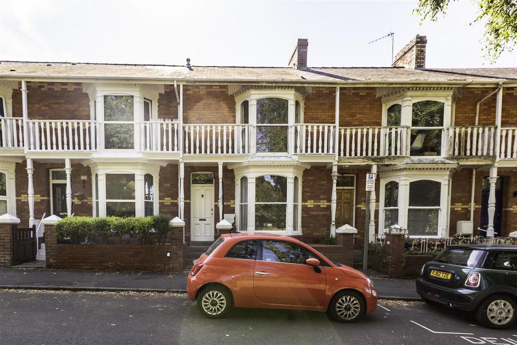 Street scene with property, parking
