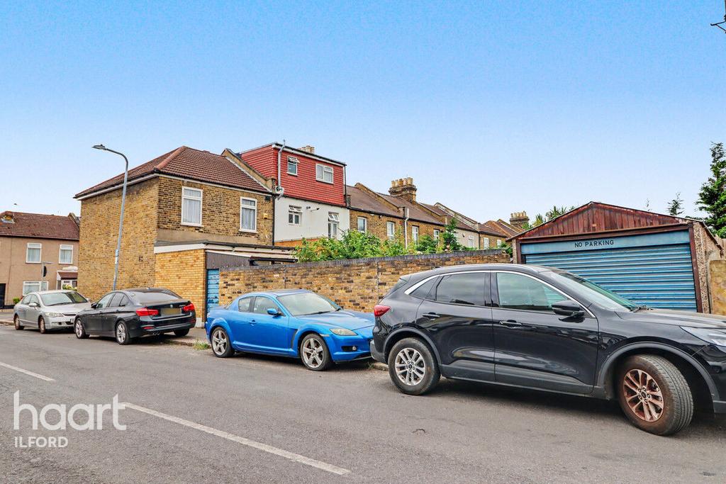 Street scene with property, parking