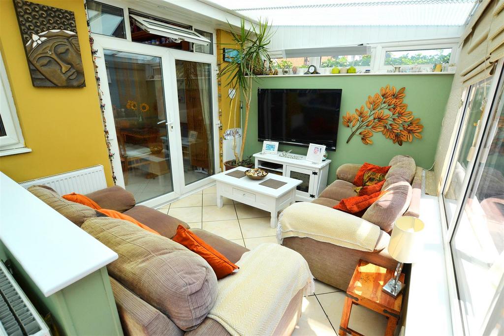 Conservatory interior, french doors leading to garden