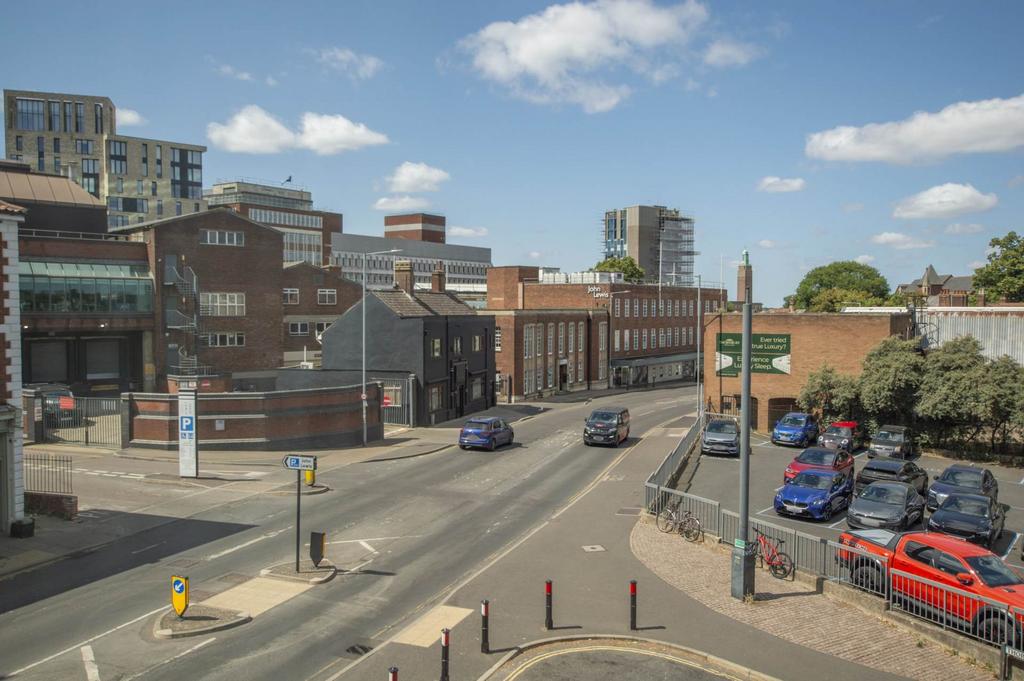 Street scene with property, parking