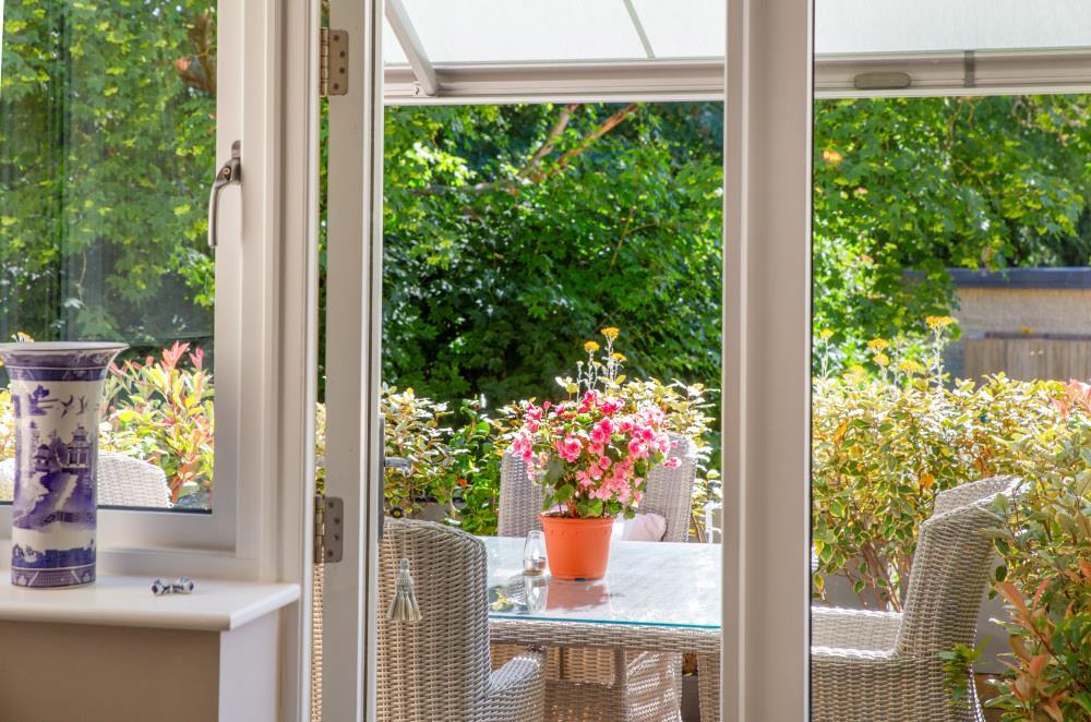 Conservatory interior, french doors leading to garden