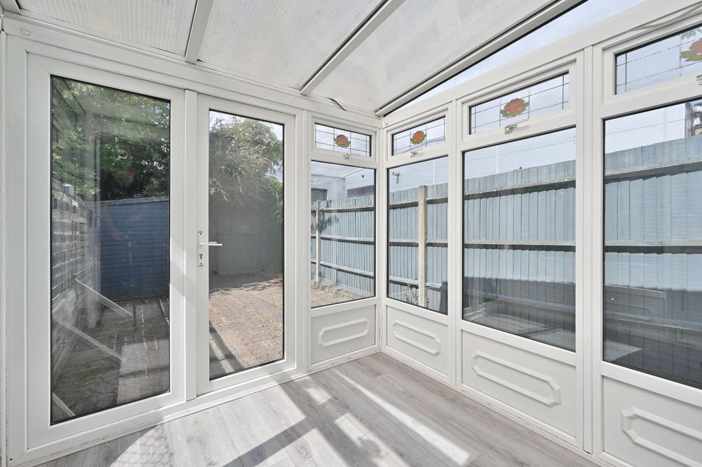 Conservatory interior, french doors leading to garden, conservatory