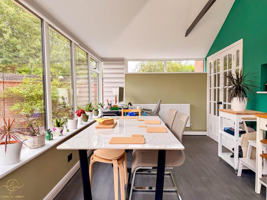Conservatory interior, french doors leading to garden