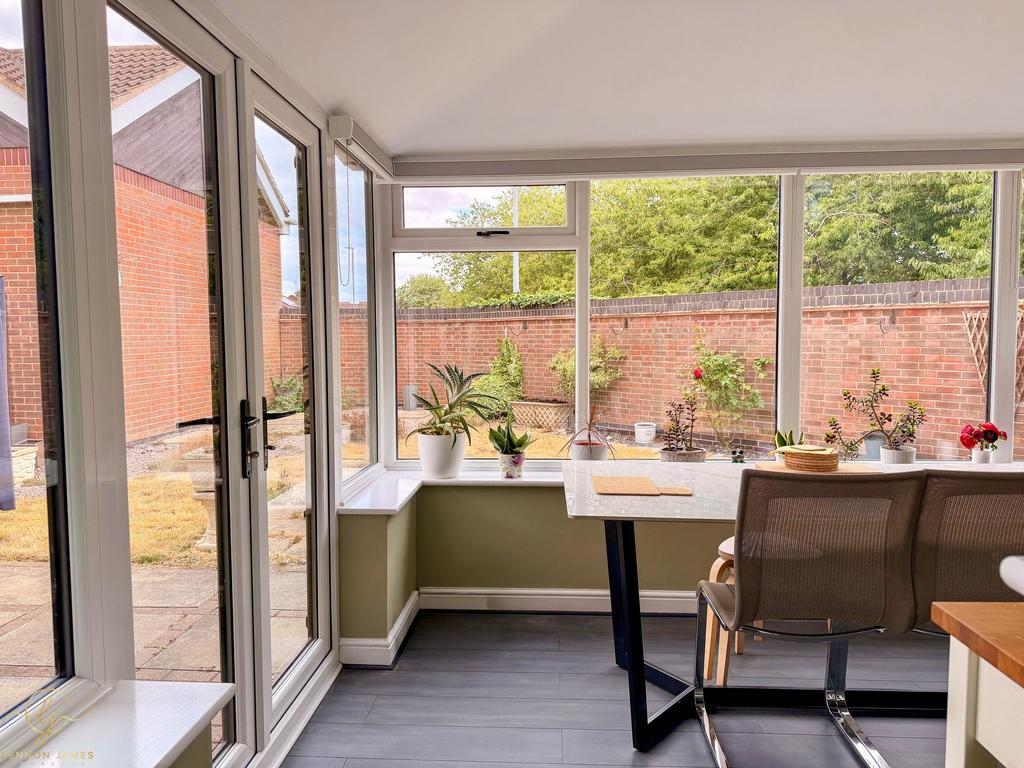Conservatory interior, french doors leading to garden