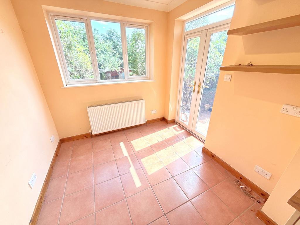 Conservatory interior, french doors leading to garden