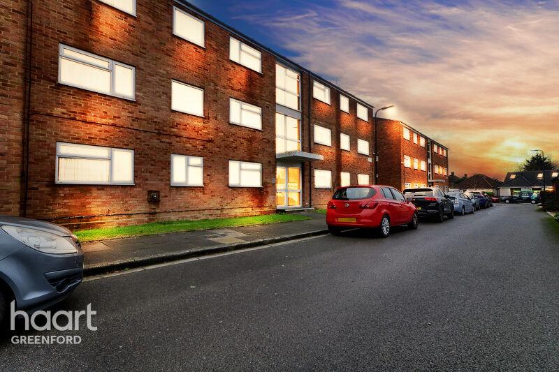 Street scene with property, parking