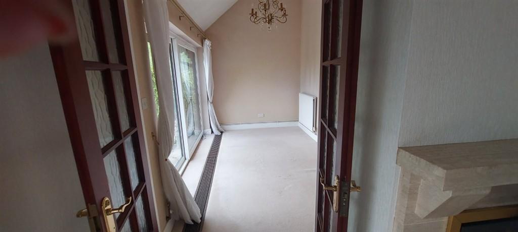 Conservatory interior, french doors leading to garden