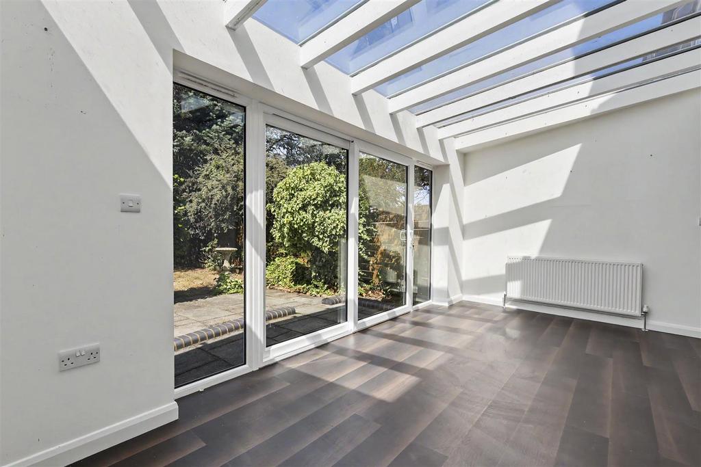 Conservatory interior, french doors leading to garden