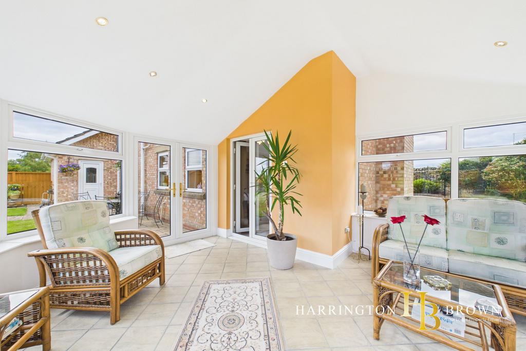 Conservatory interior, french doors leading to garden