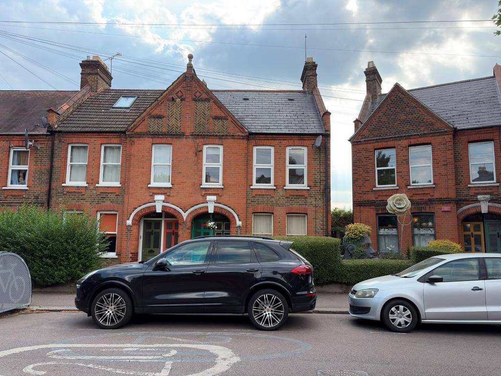 Street scene with property, parking