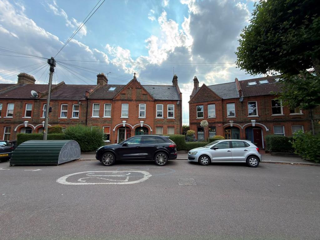 Street scene with property, parking