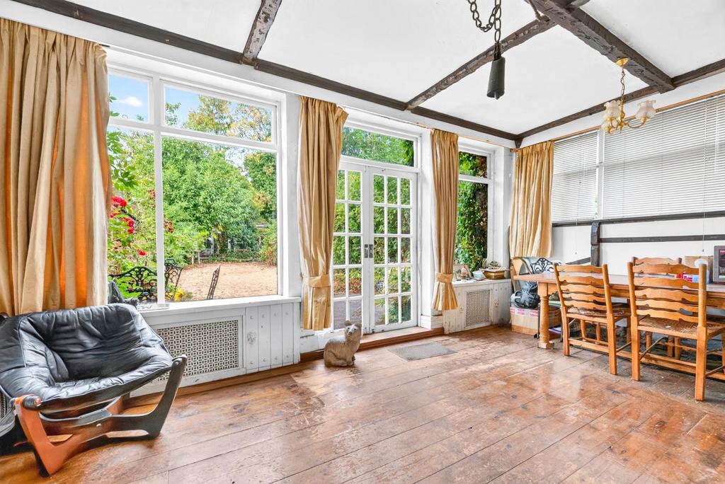 Conservatory interior, french doors leading to garden