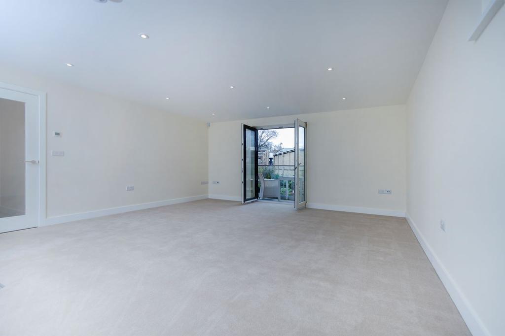 Spacious living kitchen with french doors to a balcony with glass balustrading