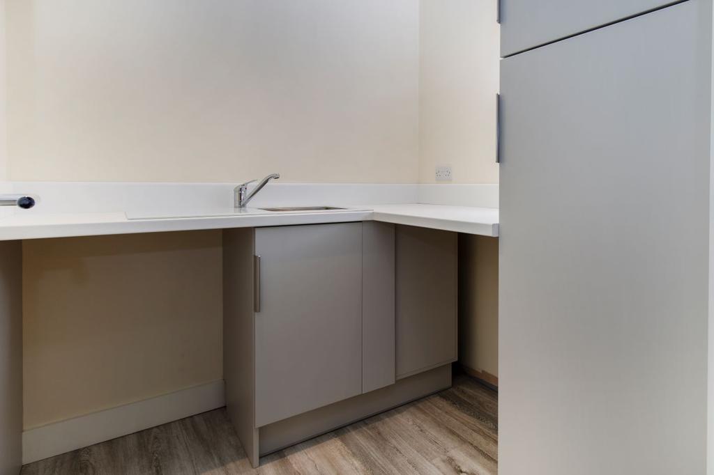 Utility room with space for a washer and tumble dryer plus ample storage cupboards