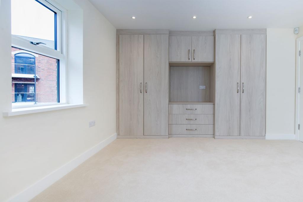 Master bedroom complete with handmade fitted wardrobes