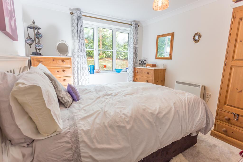 Light filled Bedroom with cupboard